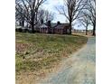 Brick ranch house with a gravel driveway at 12560 Highway 601 Hwy, Midland, NC 28107