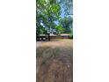 Brick ranch house with a spacious yard and mature trees at 2210 Goldmine Rd, Monroe, NC 28110