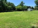 Large backyard with two sheds and a fenced area at 9400 Sandburg Ave, Charlotte, NC 28213