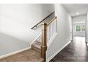 Modern staircase with wood railings and carpeted steps at 610 Cashion Rd, York, SC 29745