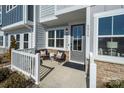 Small front porch with white railing and comfortable seating at 5919 Wetlands Aly, Charlotte, NC 28215