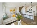Open living room and kitchen with hardwood floors and neutral colors at 5919 Wetlands Aly, Charlotte, NC 28215