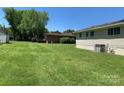 Spacious backyard with a large grassy area at 9408 Sandburg Ave, Charlotte, NC 28213