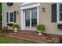 Front entrance with brick steps and elegant landscaping at 634 Carson Rd, Gastonia, NC 28052