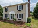 Two story house, beige siding, black shutters, brick steps at 634 Carson Rd, Gastonia, NC 28052