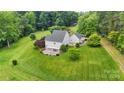 Aerial view of a house with large backyard and surrounding trees at 909 Shinnville Rd, Mooresville, NC 28115