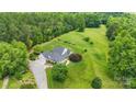 Aerial view showing a house with a spacious lawn and driveway at 909 Shinnville Rd, Mooresville, NC 28115