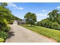 Long driveway leading to a charming house with a two-car garage at 909 Shinnville Rd, Mooresville, NC 28115