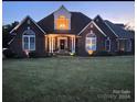 Brick home with a welcoming front porch at night at 115 Anson Dr, China Grove, NC 28023