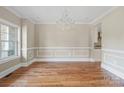 Bright dining room features hardwood floors, wainscoting, and a chandelier at 101 Mcalway Rd, Charlotte, NC 28211