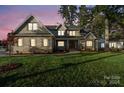 Two-story brick home with a landscaped lawn at dusk at 101 Mcalway Rd, Charlotte, NC 28211