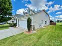 Side view of house showing garage and landscaping at 422 Bougainvillea Ct, Monroe, NC 28110
