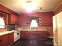 Retro kitchen with wood cabinets and white appliances at 237 W 3Rd St, Kershaw, SC 29067