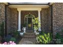 Front entry with brick columns, arched entryway, and landscaping at 4642 King Crowder Dr, Gastonia, NC 28052