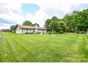 Large backyard with expansive lawn and mature trees at 425 Baucom Deese Rd, Monroe, NC 28110