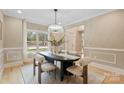 Bright dining room with modern oval table and seating for six at 4023 Randolph Rd, Charlotte, NC 28211