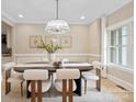 Elegant dining room featuring an oval table and six plush chairs at 4023 Randolph Rd, Charlotte, NC 28211