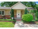 Inviting front porch with stone and brick exterior at 810 Hampton St, Shelby, NC 28152