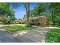 Ranch house with driveway and mature trees at 810 Hampton St, Shelby, NC 28152