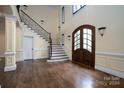Two-story entryway with hardwood floors, a grand staircase, and double doors at 2708 Chilton Pl, Charlotte, NC 28207