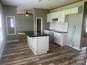 Kitchen with white cabinets, dark countertops, and an island at 200 Olin Loop, Olin, NC 28660