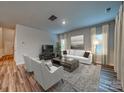 Bright and airy living room with hardwood floors and neutral decor at 2011 Merida St, Charlotte, NC 28214