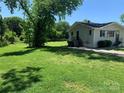 Spacious backyard with a shed and mature trees at 9416 Sandburg Ave, Charlotte, NC 28213
