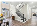Grand entryway with hardwood floors and staircase at 001 Beatties Ford Rd, Huntersville, NC 28078