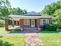 Brick home with front porch, steps, and yard at 435 W Whitley St, Norwood, NC 28128