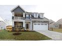 Two-story home with stone and gray siding, balcony, and a two-car garage at 1465 Ardmore Dr # 237, Sherrills Ford, NC 28673