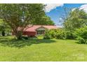 Brick ranch house with red metal roof, green lawn at 2491 Highway 274 Hwy, Cherryville, NC 28021