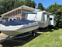 RV, boat, and storage building on a grassy lot at 332 Mount View Ln, New London, NC 28127