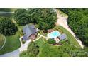 Aerial view of home, pool, and detached structures at 5610 Golden Pond Dr, Indian Trail, NC 28079