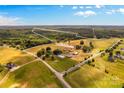 Aerial view of property showing home, pond, and expansive acreage at 11681 Mooresville Rd, Davidson, NC 28036