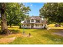 Two story home with wrap around porch and large yard at 11681 Mooresville Rd, Davidson, NC 28036