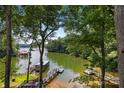 Lakefront view with private docks and lush greenery at 144 Hickory Hollow Ln, Taylorsville, NC 28681