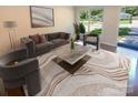 Virtually staged living room featuring modern furniture and large windows at 1913 Herrin Ave, Charlotte, NC 28205