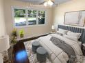 Virtually staged bedroom with a plush bed and ample natural light at 1913 Herrin Ave, Charlotte, NC 28205