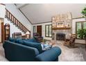 Living room with stone fireplace, vaulted ceiling and hardwood floors at 4438 River Rd, Hickory, NC 28602