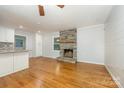 Living room with hardwood floors, stone fireplace, open kitchen at 805 Rowan Avenue Ext, Spencer, NC 28159