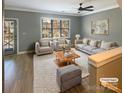 Virtually staged living room with neutral colored furniture and hardwood floors at 210 Harbour Place Dr, Davidson, NC 28036