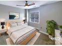 Virtually staged main bedroom with a large bed and neutral color scheme at 210 Harbour Place Dr, Davidson, NC 28036