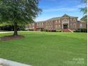 Large brick home with lush green lawn and driveway at 9100 Woodhall Lake Dr, Waxhaw, NC 28173