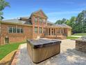 Relaxing hot tub on patio next to outdoor kitchen at 9100 Woodhall Lake Dr, Waxhaw, NC 28173
