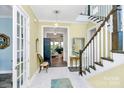 Bright entryway with elegant staircase and French doors at 2031 Masons Bend Dr, Fort Mill, SC 29708