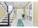 Elegant entryway with a marble floor, a staircase, and french doors at 2031 Masons Bend Dr, Fort Mill, SC 29708