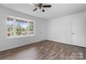 Spacious living room with laminate flooring, a ceiling fan, and ample natural light at 303 Cedarwood Dr, Shelby, NC 28152