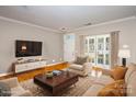 Virtually staged living room featuring hardwood floors and access to backyard at 1804 Robinwood Village Dr, Gastonia, NC 28054