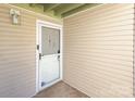 Exterior condo entrance with screen door and tan siding at 1602 Eagles Pl # J103, Rock Hill, SC 29732
