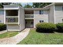 Tan colored apartment building with a walkway and landscaping at 1602 Eagles Pl # J103, Rock Hill, SC 29732
